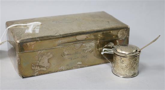 An Edwardian silver cigarette box and a silver mustard pot and spoon.